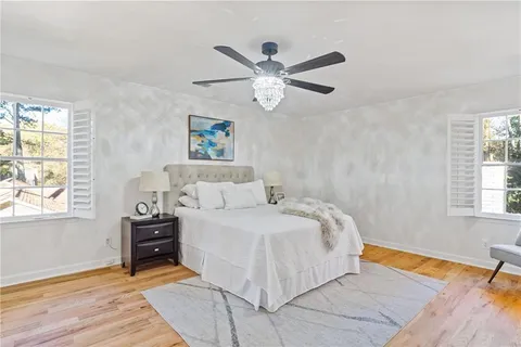 a bathroom with a granite countertop sink a mirror a bathtub and shower
