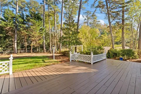 a view of a house with a backyard and a tree