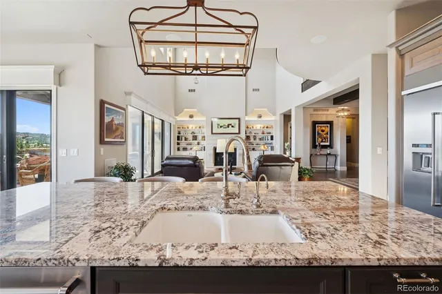 a living room with fireplace furniture and a chandelier