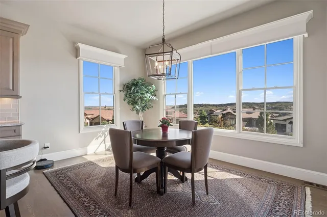 a dining room with furniture window and wooden floor