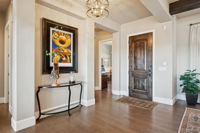 a view of an entryway with wooden floor