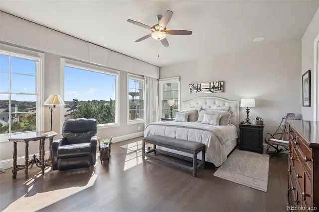 a bedroom with furniture and a large window