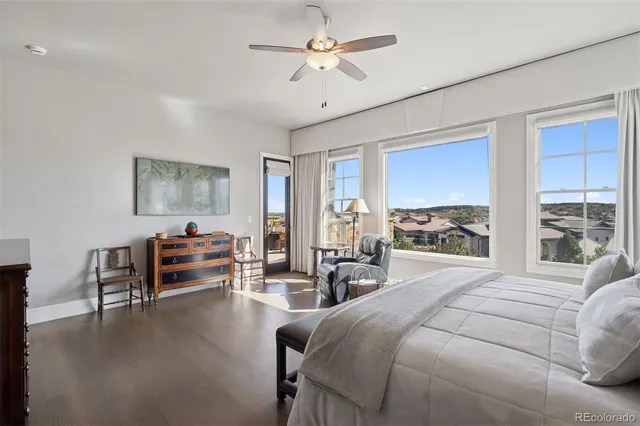 a bedroom with furniture and a large window