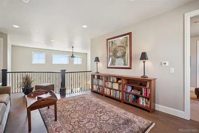 a view of a bedroom with furniture and wooden floor