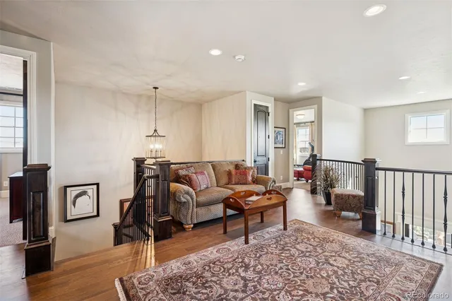 a living room with furniture a rug and a window