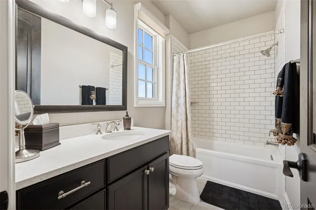 a bathroom with a sink a toilet a mirror and shower