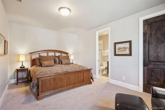 a bedroom with a bed a couch and dresser