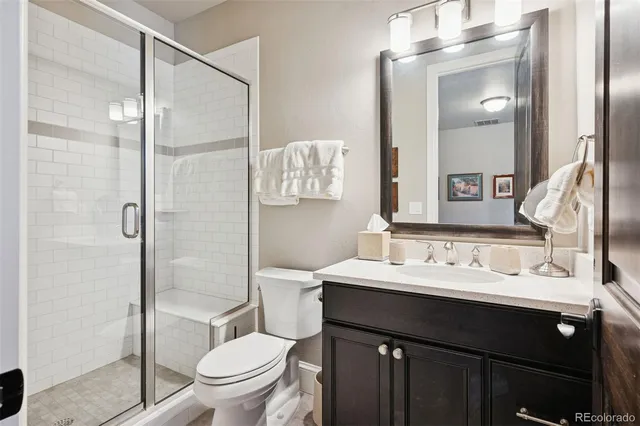 a bathroom with a sink vanity mirror and toilet