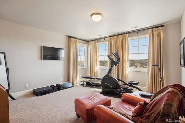 a room with furniture gym equipment and a window