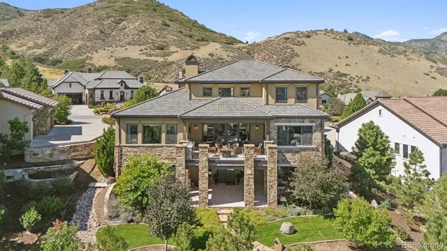 an aerial view of a house with a yard and potted plants