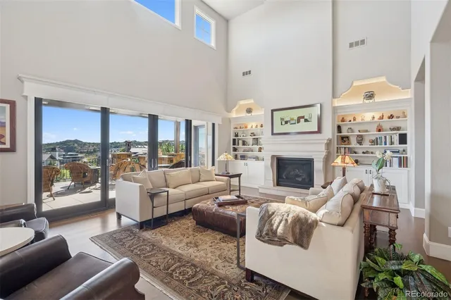 a living room with furniture large window and a fireplace