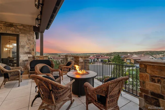 a view of a roof deck with a table and chairs