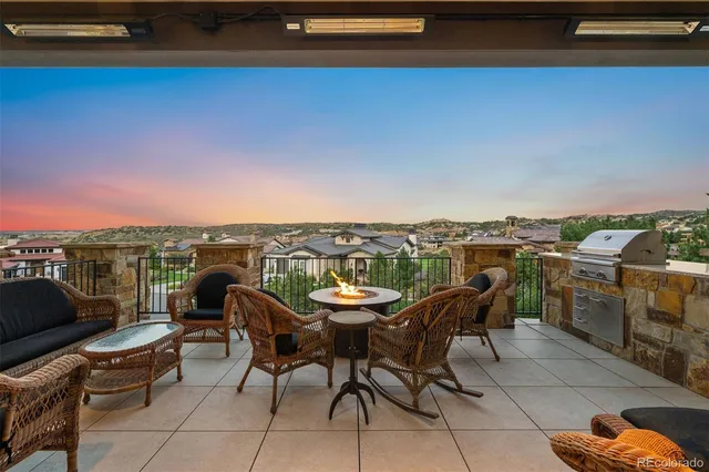 a view of a roof deck with furniture