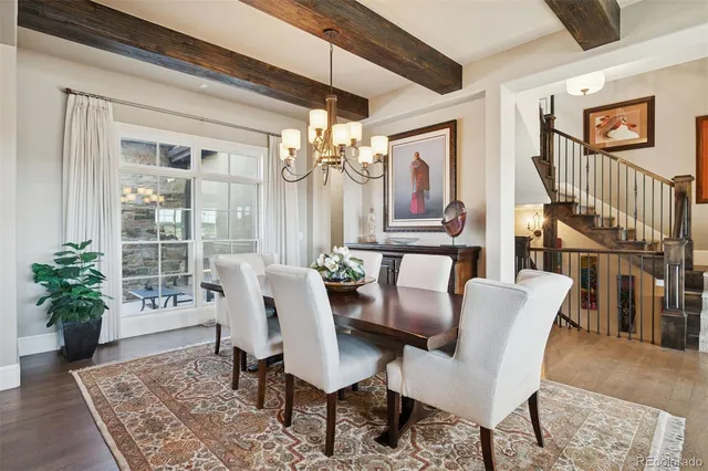 a dining room with furniture potted plants and wooden floor