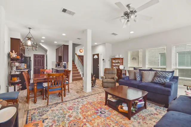 a living room with furniture and a view of kitchen
