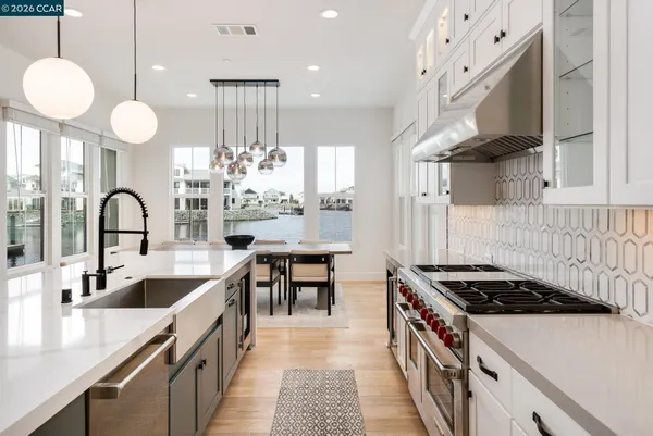 a kitchen that has a lot of cabinets a sink and a stove
