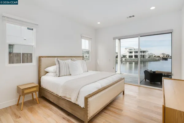 a bedroom with a bed and glass window