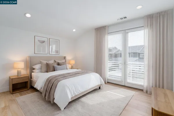 a bedroom with a bed and a window