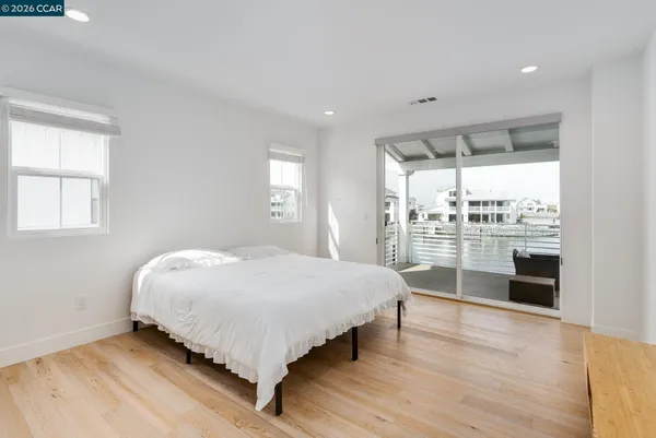 a bedroom with a bed and a large window