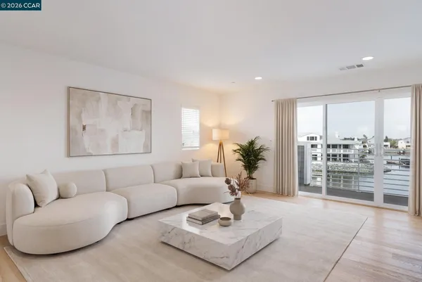 a living room with furniture and view of kitchen