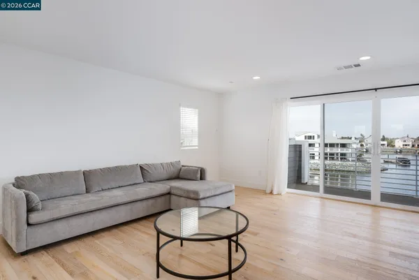 a living room with furniture and view of kitchen