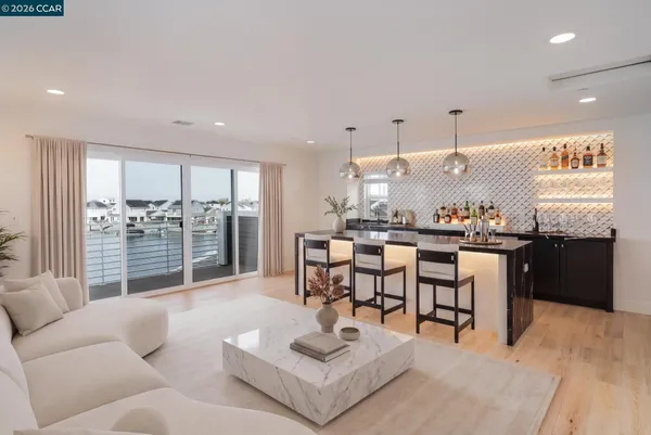a living room with furniture and kitchen view