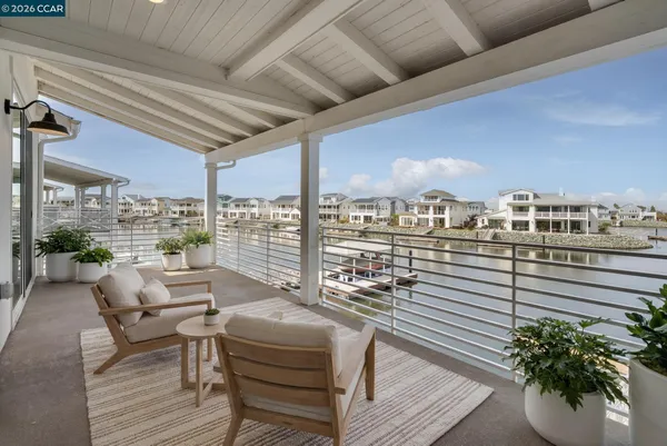 a balcony with furniture and a potted plant