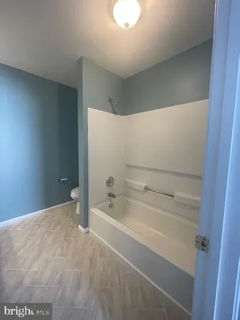 a bathroom with a bathtub and toilet