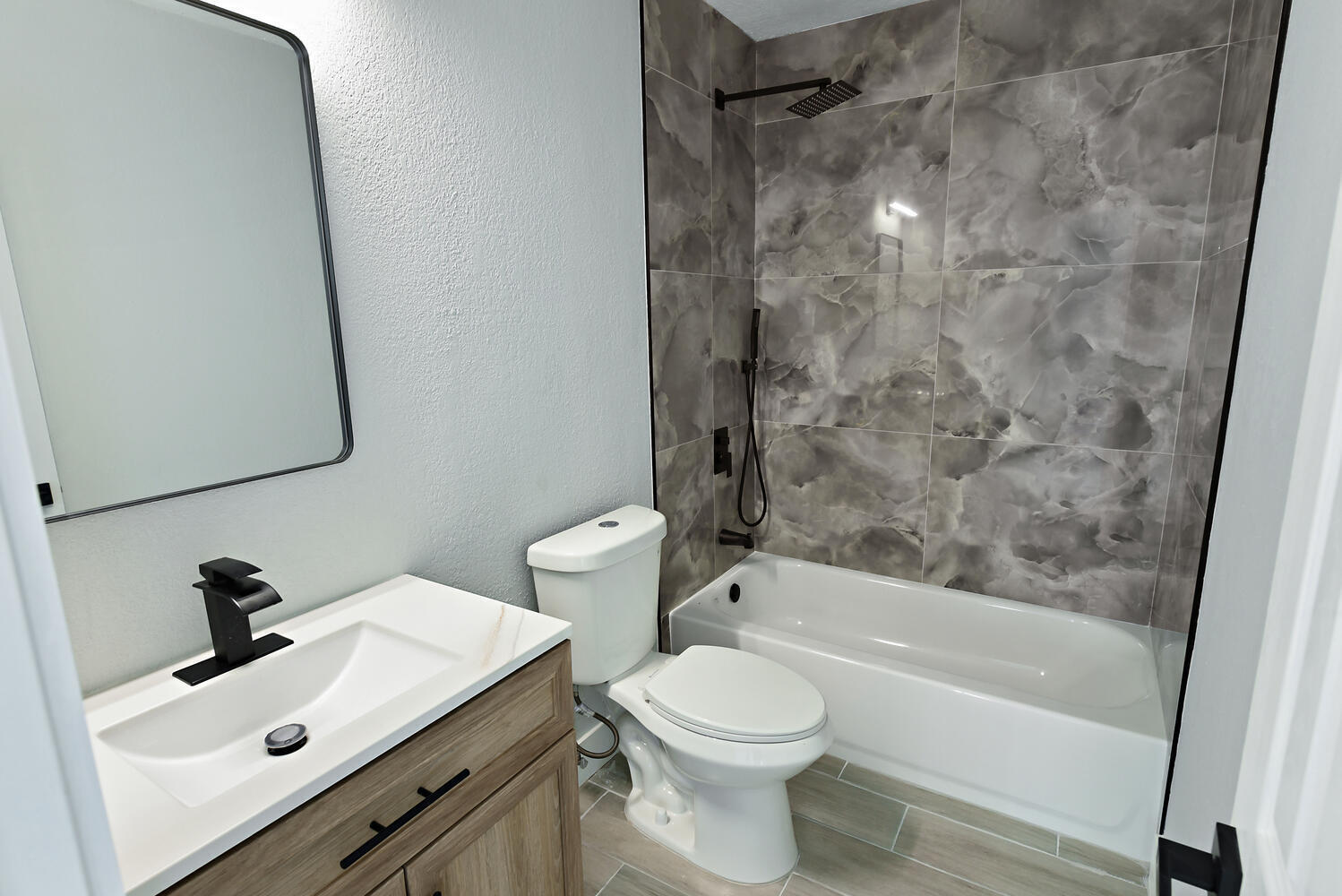 8587 Southwest 18th Avenue Stuart, FL 34997 - Photo 22 of 39 a bathroom with a sink mirror toilet and bathtub