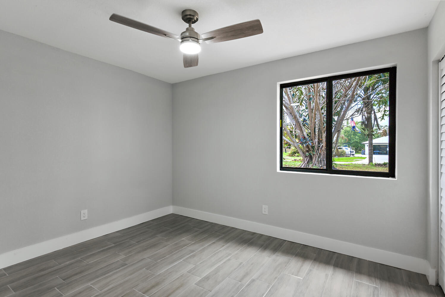 8587 Southwest 18th Avenue Stuart, FL 34997 - Photo 23 of 39 wooden floor in an empty room with a window