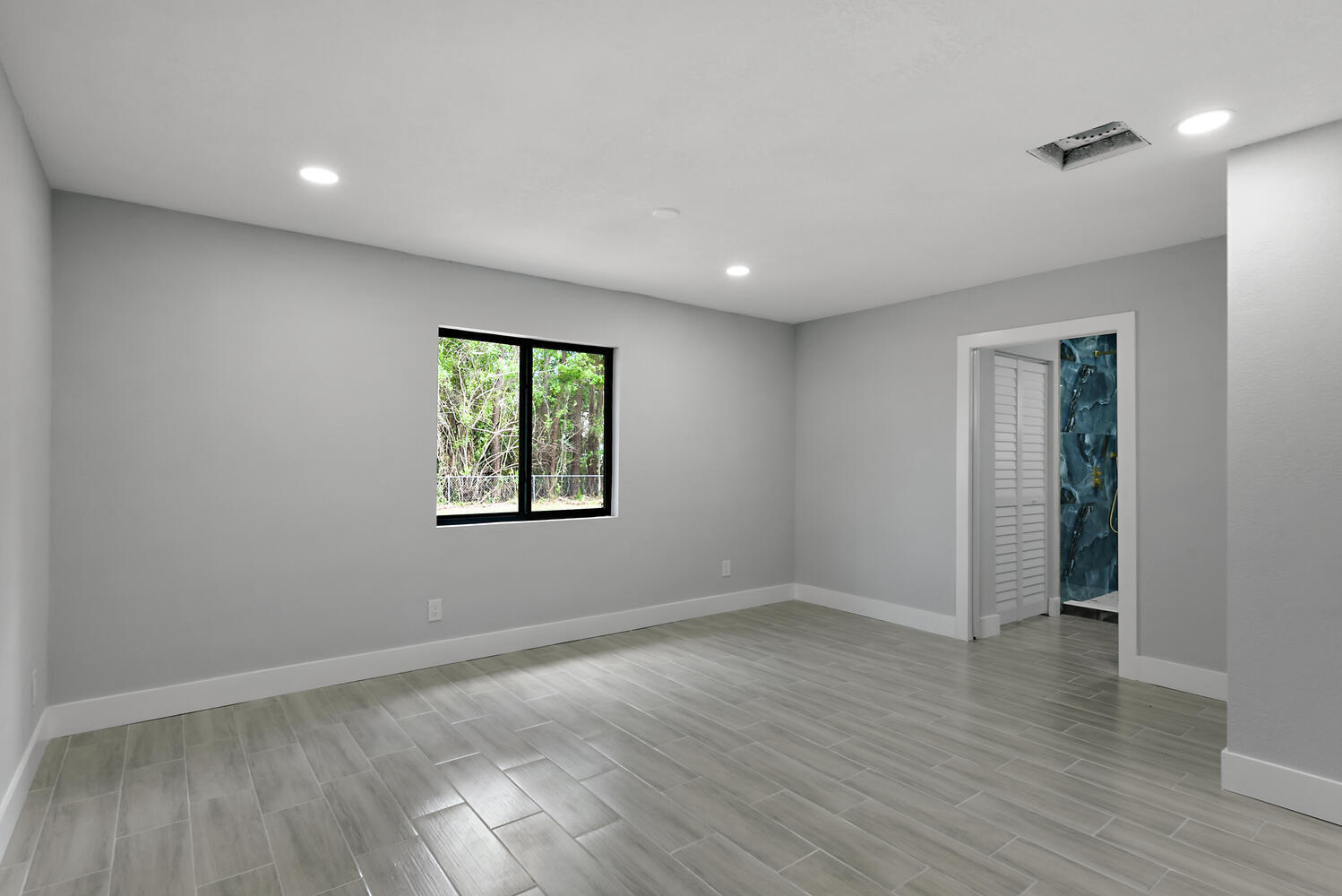 8587 Southwest 18th Avenue Stuart, FL 34997 - Photo 25 of 39 an empty room with wooden floor and window