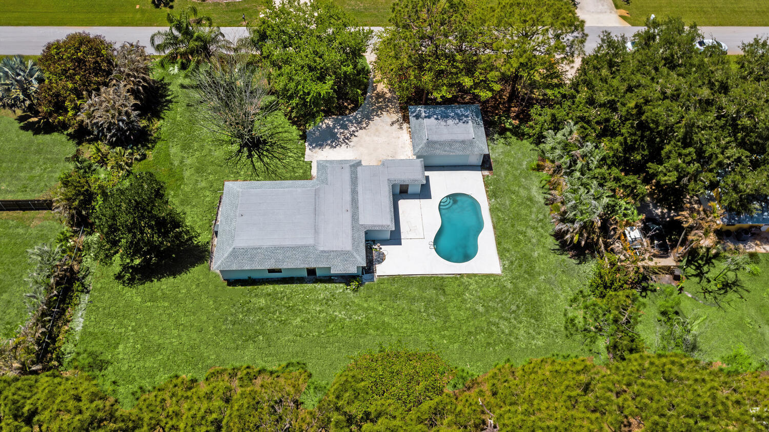 8587 Southwest 18th Avenue Stuart, FL 34997 - Photo 38 of 39 an aerial view of residential house with outdoor space and trees all around