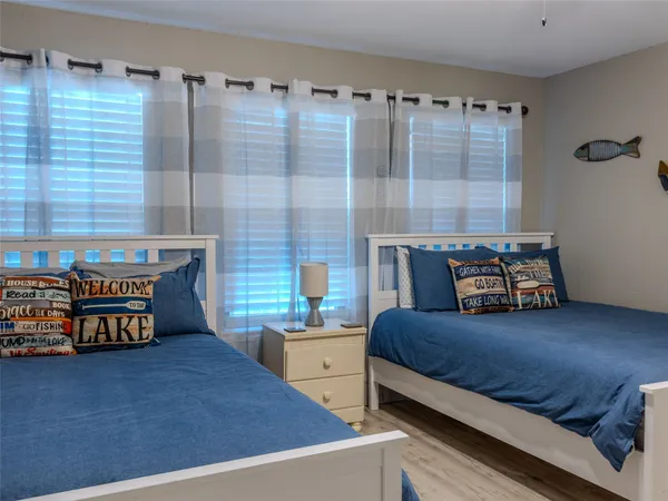 a bedroom with bed and a large window