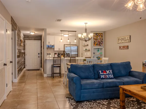 a living room with furniture and kitchen view