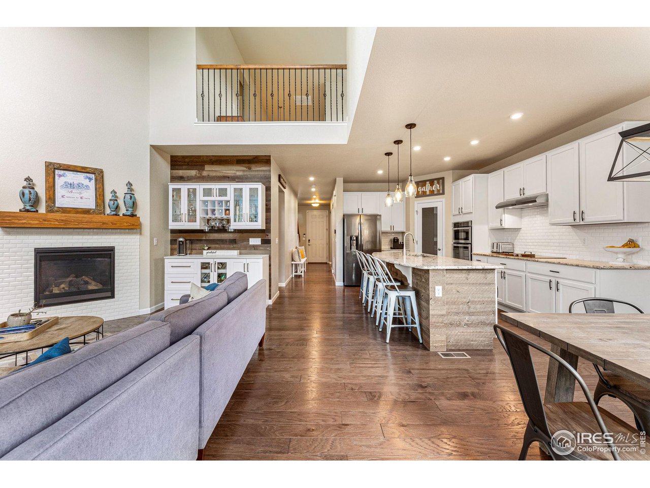 1908 Pioneer Circle Lafayette, CO 80026 - Photo 12 of 40 a kitchen with stainless steel appliances granite countertop a stove top oven a sink a dining table and chairs