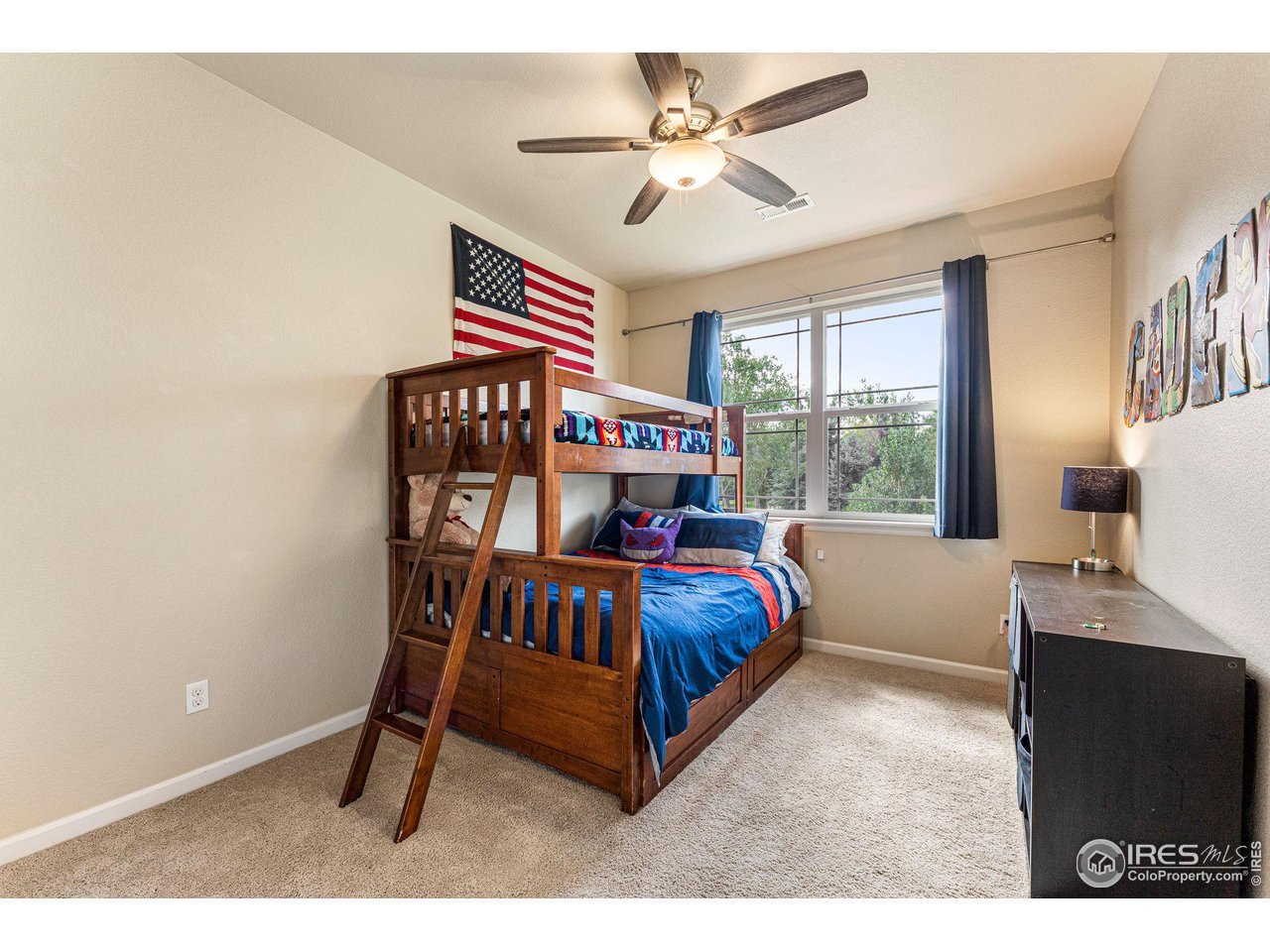 1908 Pioneer Circle Lafayette, CO 80026 - Photo 21 of 40 a bedroom with a bed and a chandelier