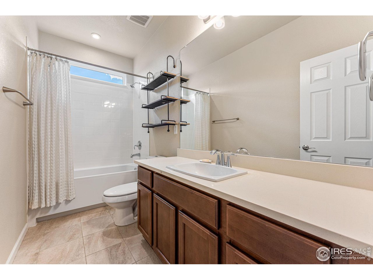 1908 Pioneer Circle Lafayette, CO 80026 - Photo 22 of 40 a bathroom with a sink a toilet and shower
