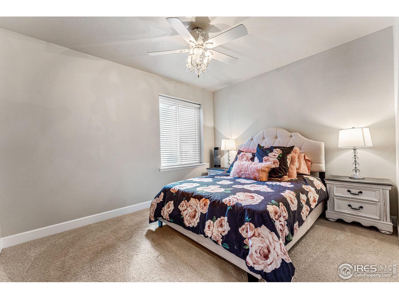 1908 Pioneer Circle Lafayette, CO 80026 - Photo 28 of 40 a bedroom with a bed and a chandelier