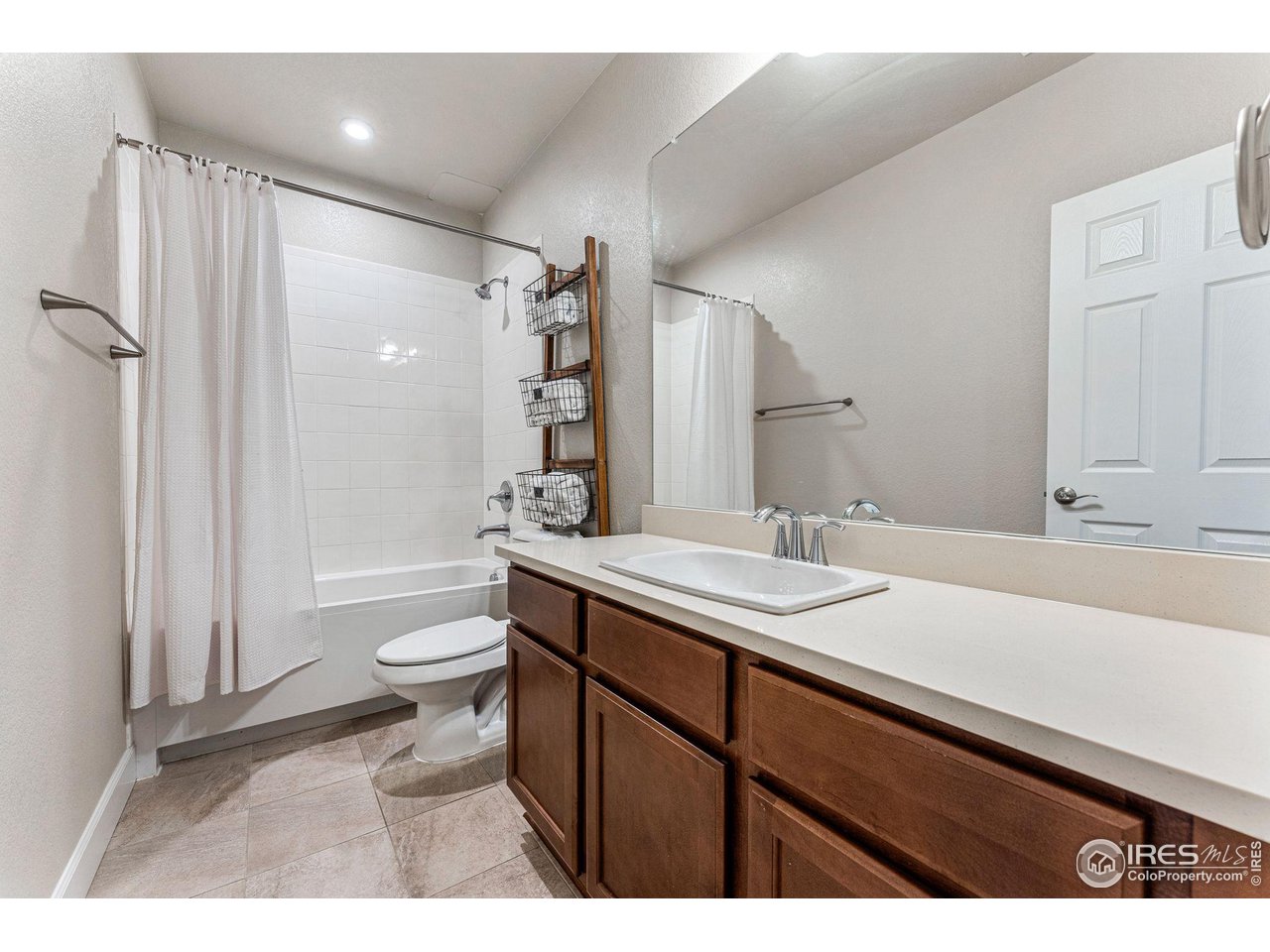 1908 Pioneer Circle Lafayette, CO 80026 - Photo 29 of 40 a bathroom with a sink toilet a mirror and shower
