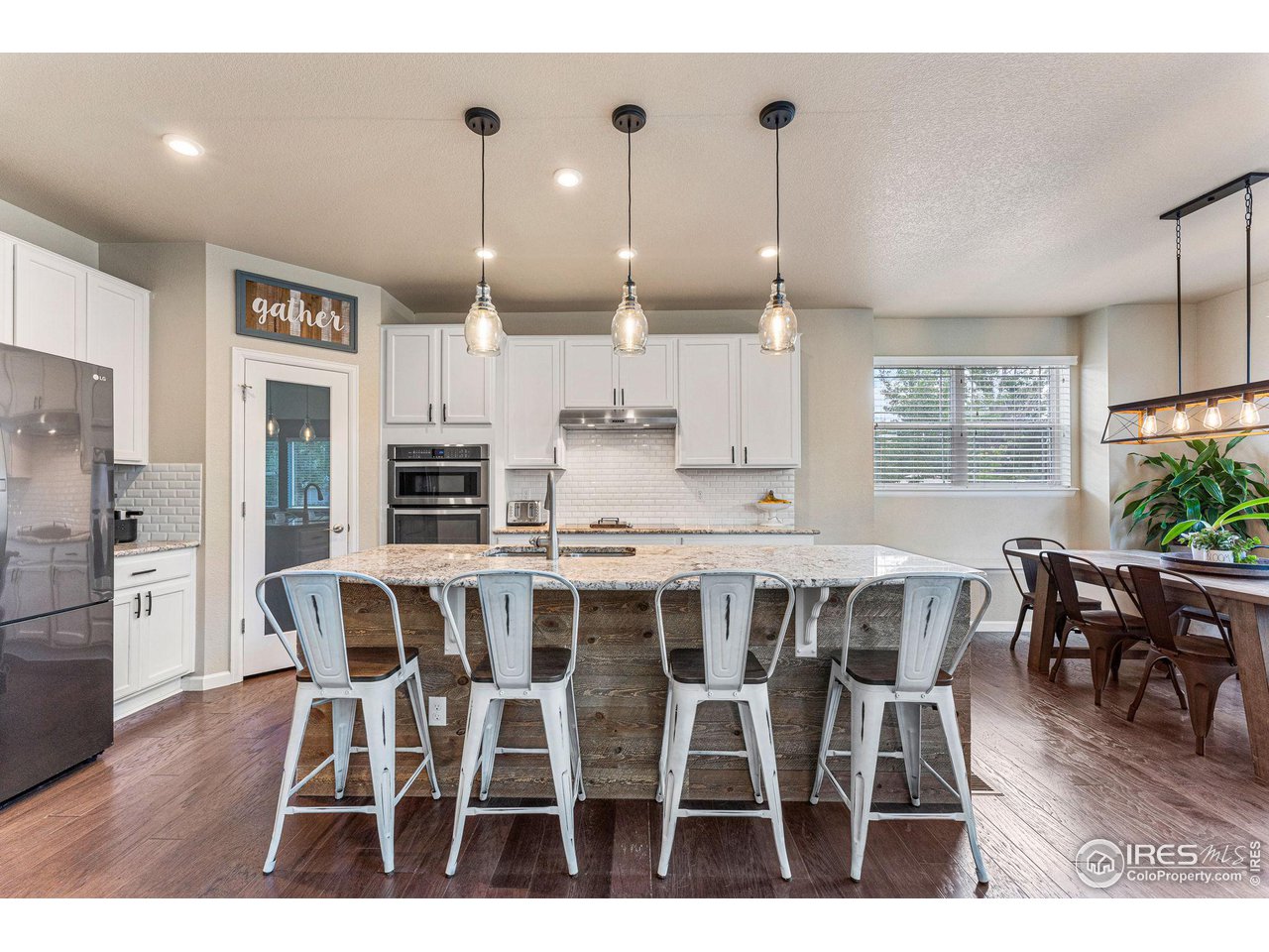 1908 Pioneer Circle Lafayette, CO 80026 - Photo 3 of 40 a view of a dining room with furniture window and wooden floor