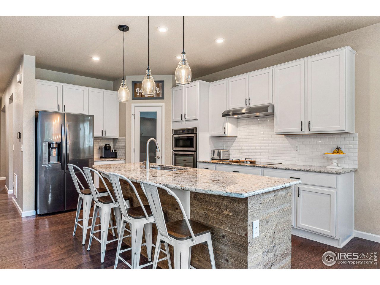 1908 Pioneer Circle Lafayette, CO 80026 - Photo 4 of 40 a kitchen that has a lot of cabinets a sink and appliances