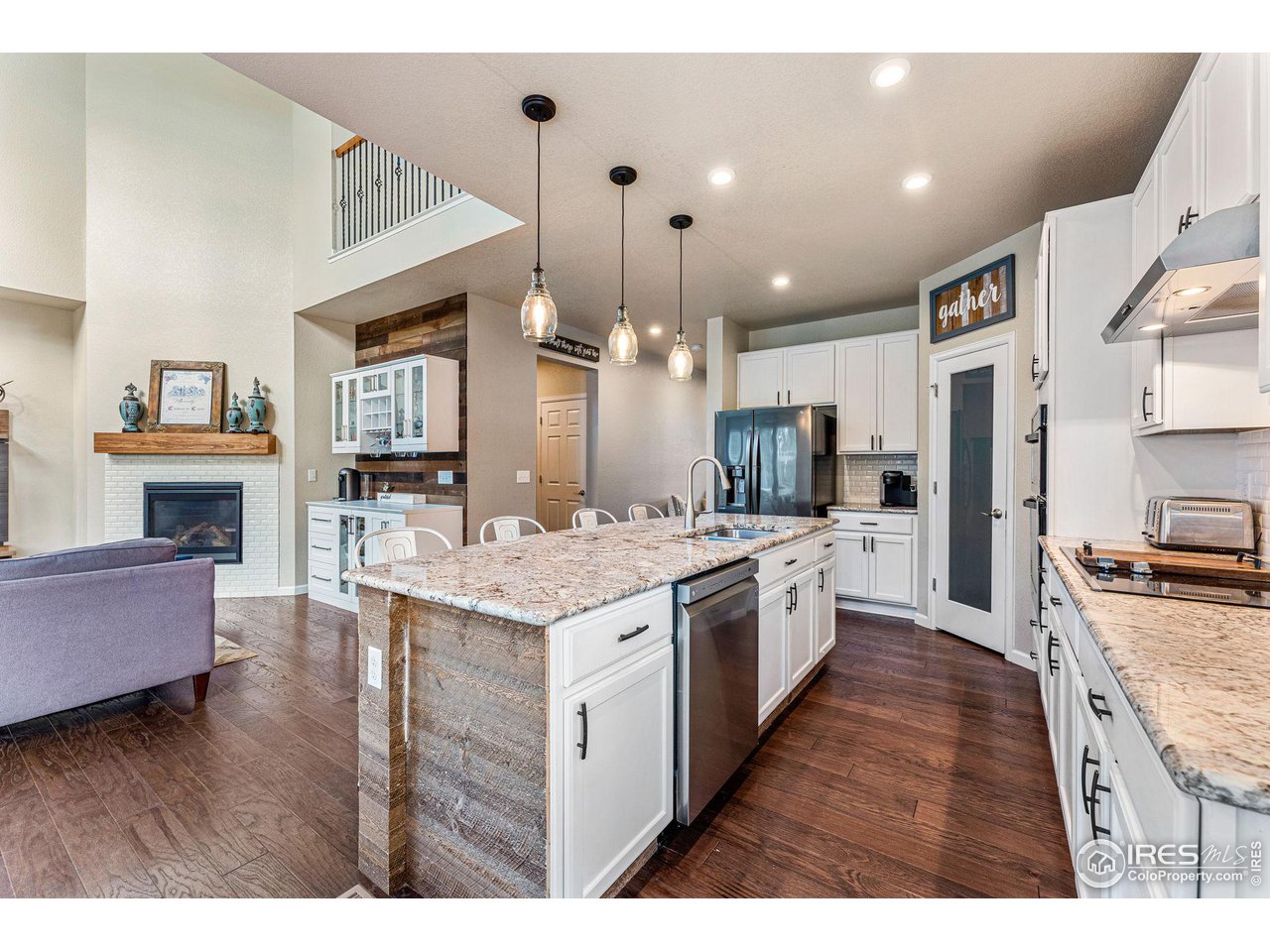 1908 Pioneer Circle Lafayette, CO 80026 - Photo 6 of 40 a large kitchen with granite countertop a large kitchen island and stainless steel appliances