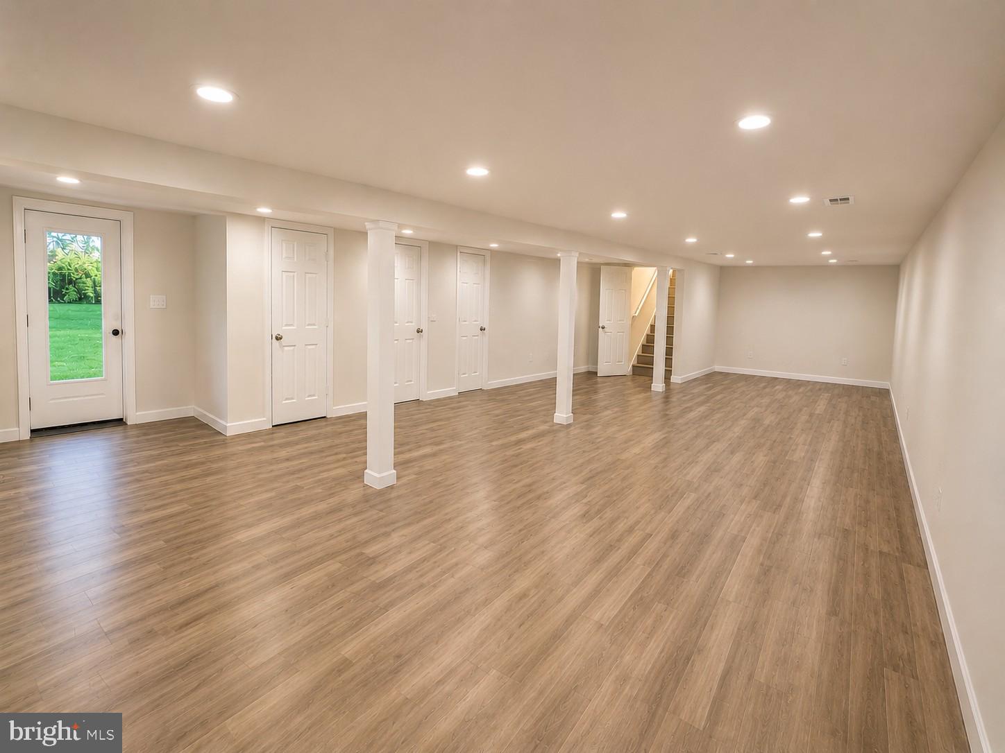 12658 Scaggsville Road Highland, MD 20777 - Photo 9 of 13 a view of an empty room with wooden floor and windows