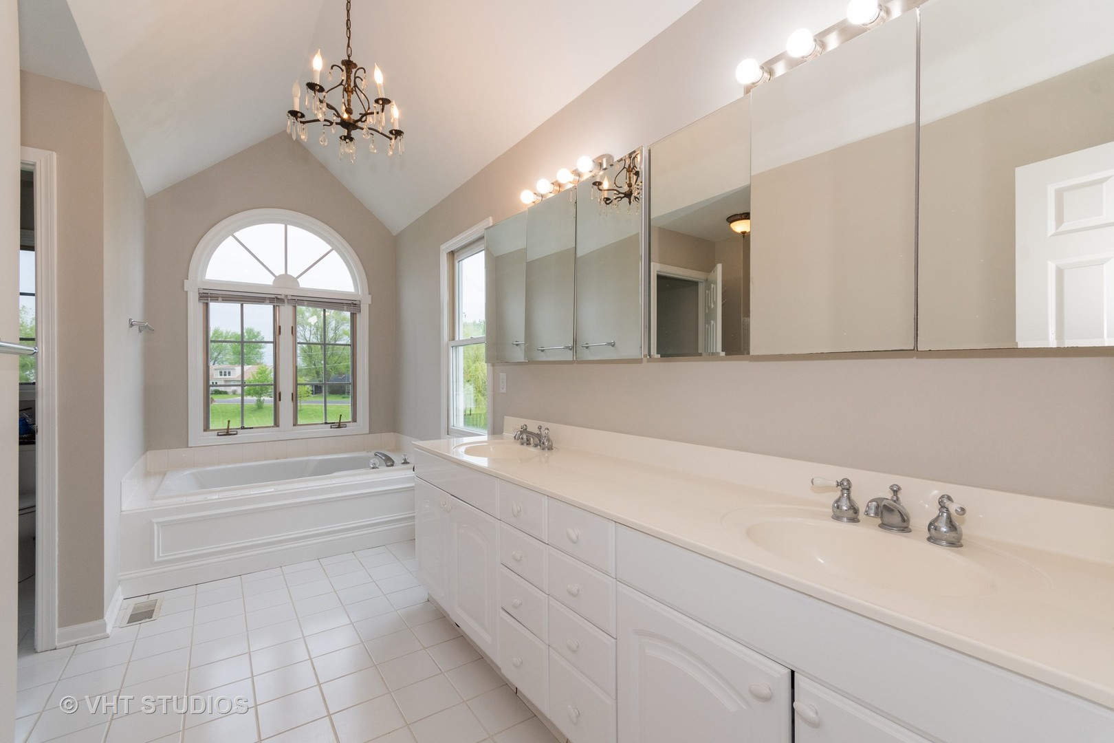 41W910 Verhaeghe Road St. Charles, IL 60175 - Photo 11 of 18 a spacious bathroom with a sink a large mirror and a bathtub next to a window