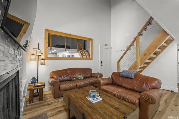 a kitchen that has a table chairs in it and wooden floors