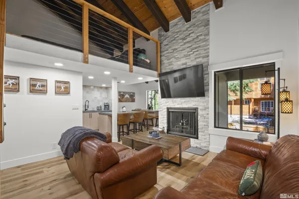 a kitchen with stainless steel appliances granite countertop a table and chairs in it