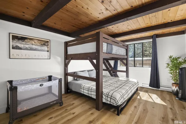 a bedroom with a bed and a large window