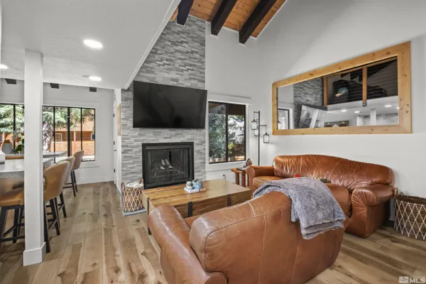 a living room with furniture fireplace and flat screen tv