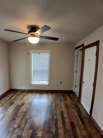 a view of room with a ceiling fan and window
