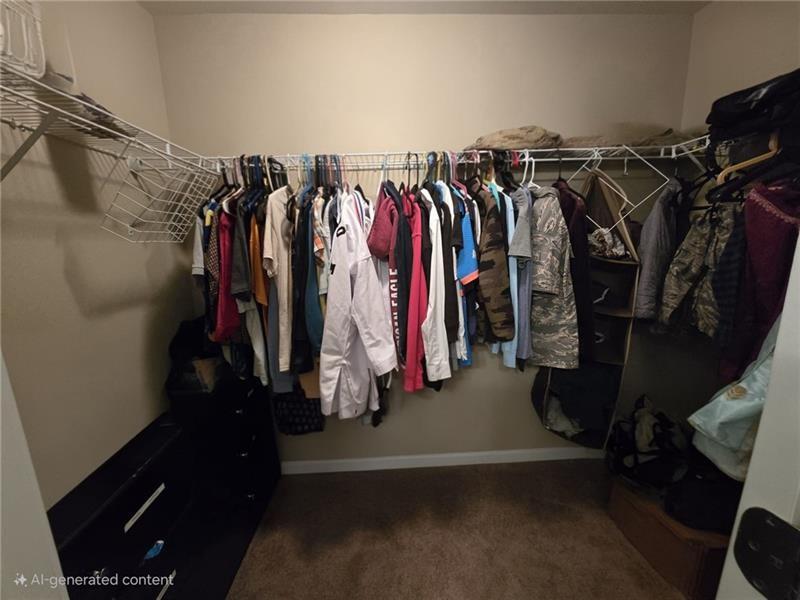 6850 Rocking Horse Lane Cumming, GA 30040 - Photo 14 of 36 a view of walk in closet with clothes